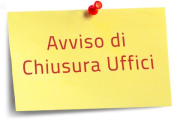Foglio giallo appeso ad una parete con un puntaspilli rosso con su scritto "avviso di chiusura uffici"